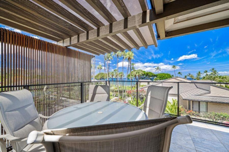 a patio with a table and chairs on a balcony at WAILEA ELUA, #0702 condo in Wailea