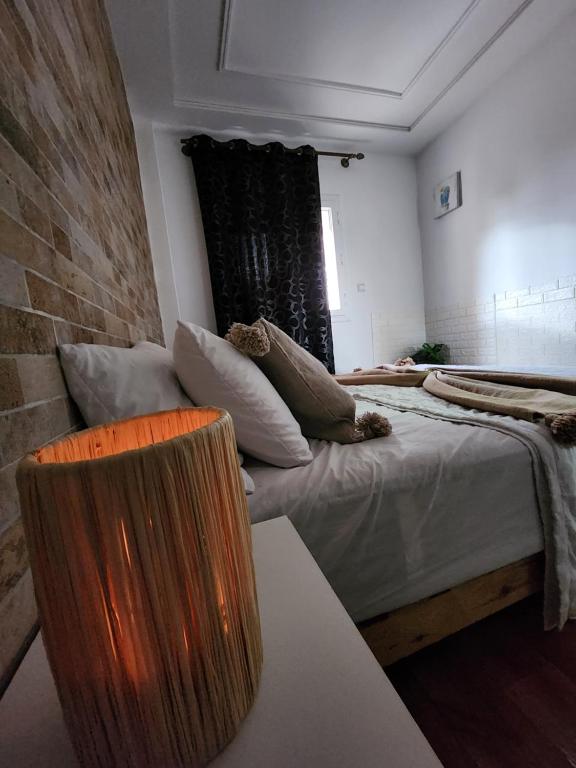 a room with two beds and a couch in it at FamilyConfort Saidia in Saïdia