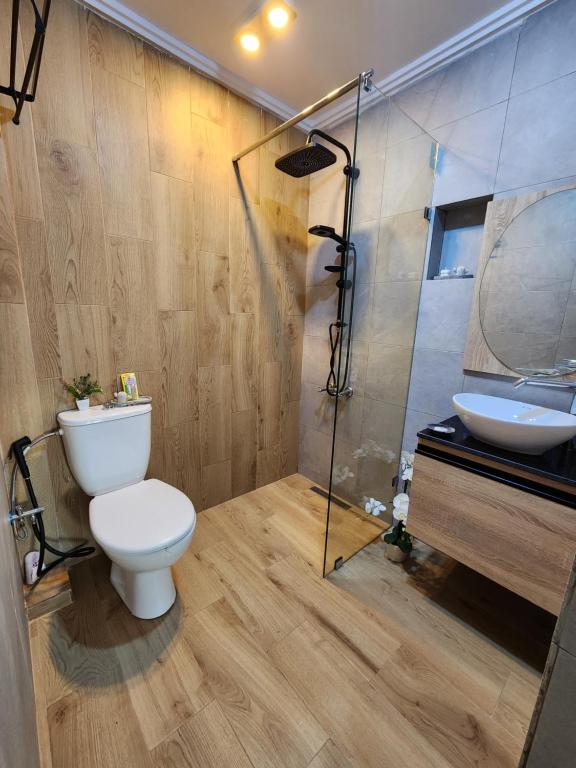 a bathroom with a toilet and a sink and a shower at FamilyConfort Saidia in Saïdia
