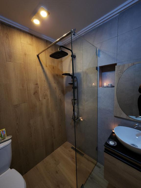 a bathroom with a shower and a toilet and a sink at FamilyConfort Saidia in Saïdia
