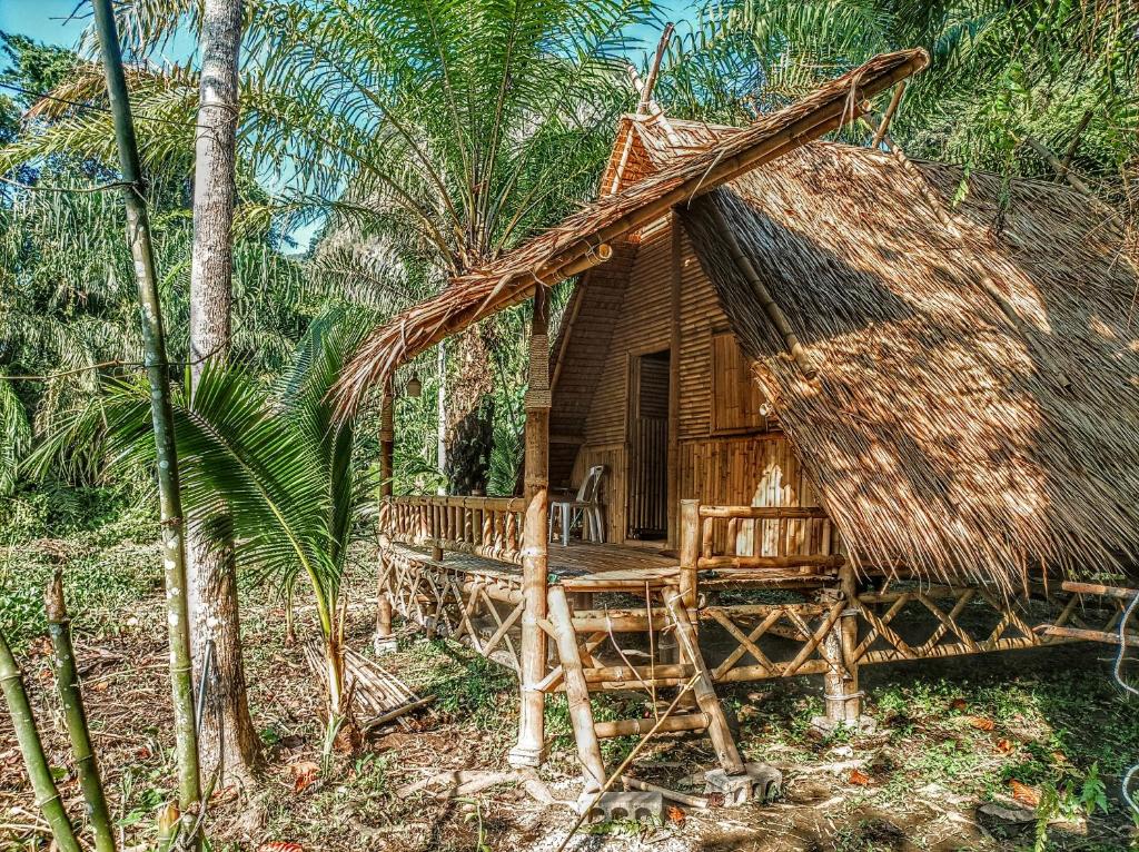 a small hut with a thatched roof in a forest at KRABI BAMBOO KINGDOM at AOLUEK PARADISE in Ao Luk