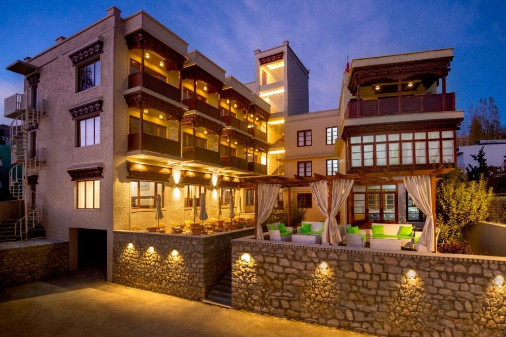 a building with a stone wall in front of it at Ashoka Ladakh in Leh