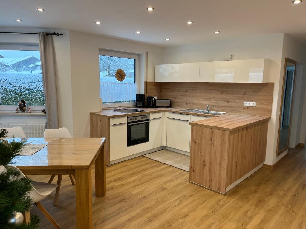 a kitchen with a table and a counter top at Ferienwohnungen Angelika in Garmisch-Partenkirchen