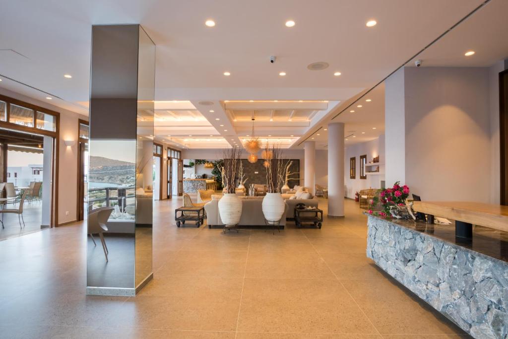 a lobby of a house with a dining area at Aegean Village Beachfront Resort in Amoopi