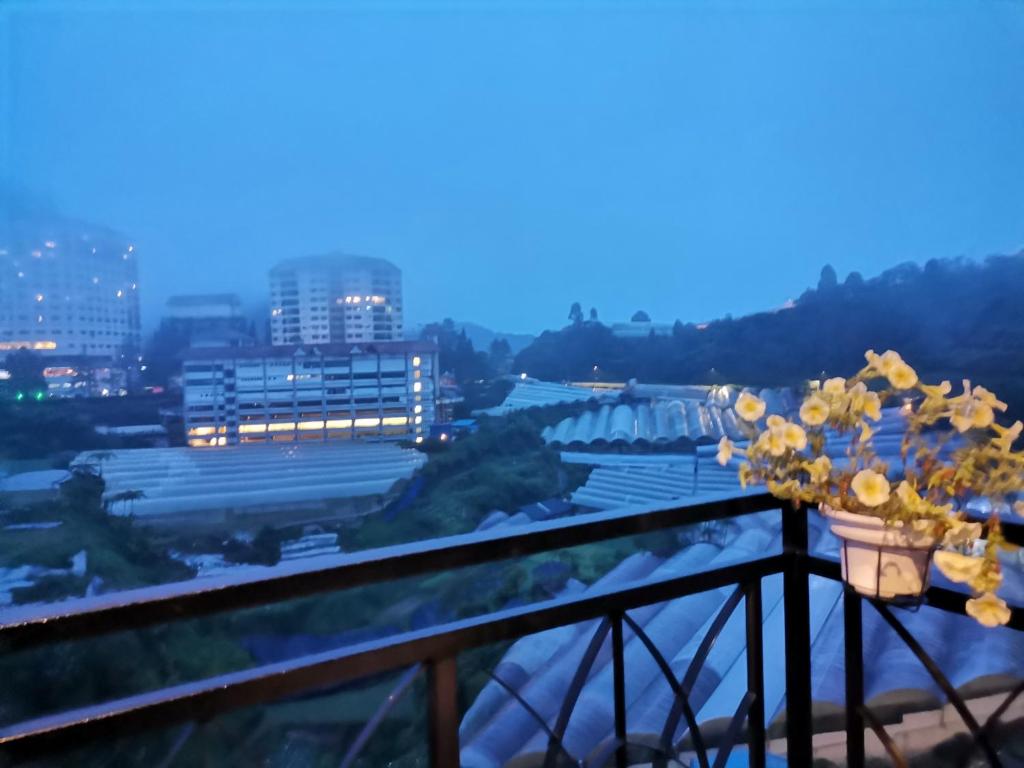 a view from the balcony of a building with flowers at Dzulstudio(Muslim) Nova Highland in Brinchang