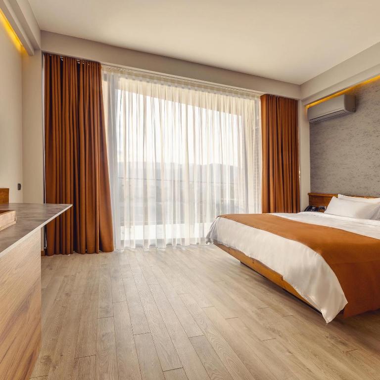 Postel nebo postele na pokoji v ubytování Ivy Hotel