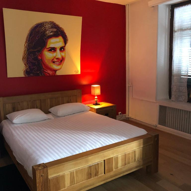 une chambre avec un lit avec un tableau sur le mur dans l'établissement Mont Blanc Residence, à Saint-Gervais-les-Bains