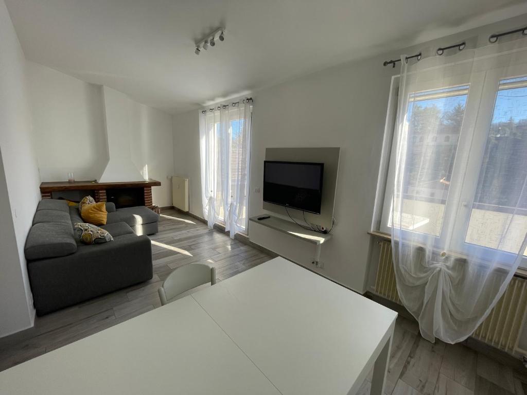 La terrazza sul Trebbia في ريفرغارو: غرفة معيشة مع أريكة وتلفزيون