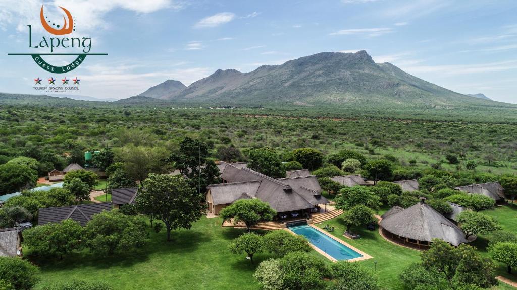an aerial view of a luxury house with a pool and mountains at Lapeng Guest Lodge in Burgersfort