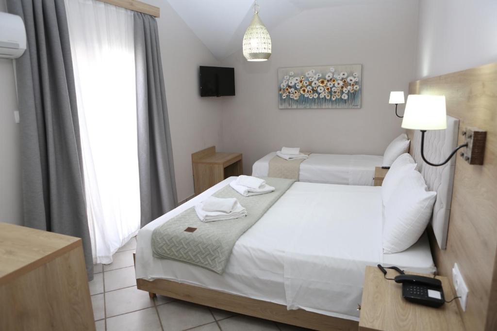 Postel nebo postele na pokoji v ubytování Caretta - Caretta Hotel