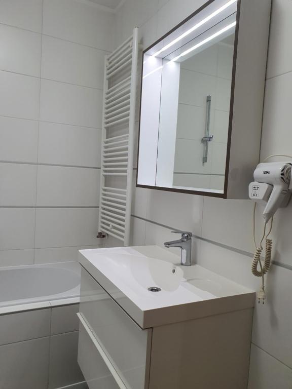a white bathroom with a sink and a mirror at Apartment I Love Zagreb, free private parking in Zagreb