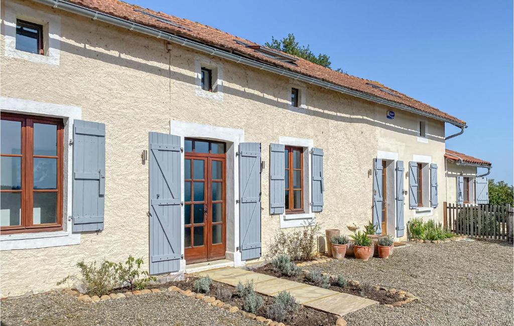 a house with blue shutters and a yard at Cozy Home In Monfaucon With Wifi in Monfaucon