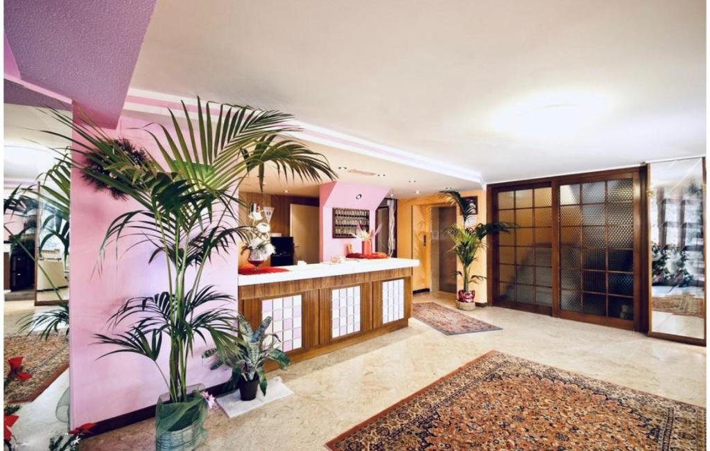 a living room with plants in a room at Hotel Naica in Rimini