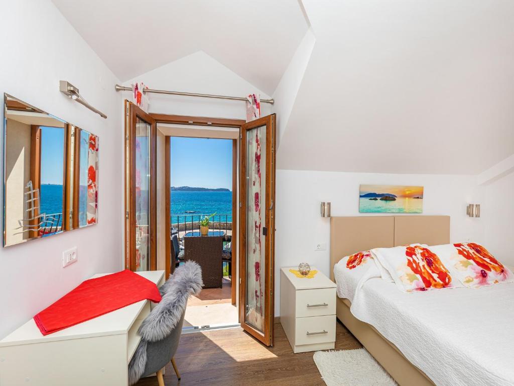 a bedroom with a view of the ocean at Villa Ana Apartments in Mlini
