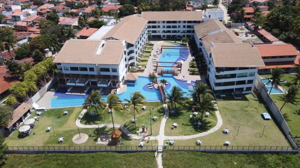 an aerial view of a resort with a swimming pool at Lindo flat no Maui Beach Residence C201 in Tamandaré
