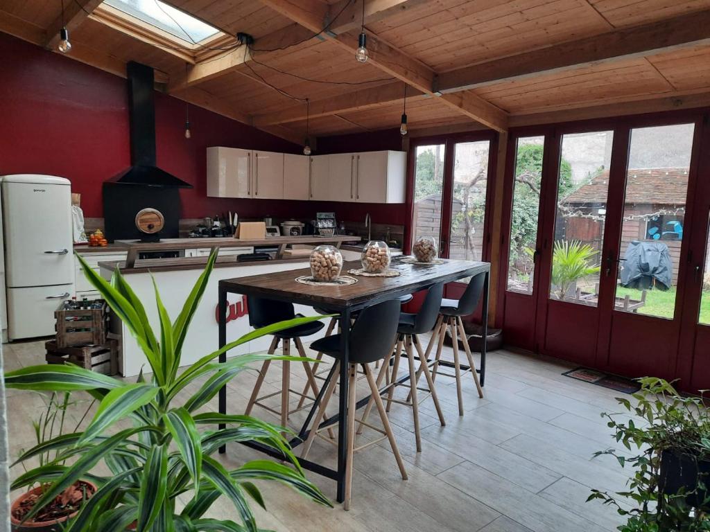 a kitchen with a island with bar stools at A Ribeira in Châteauroux