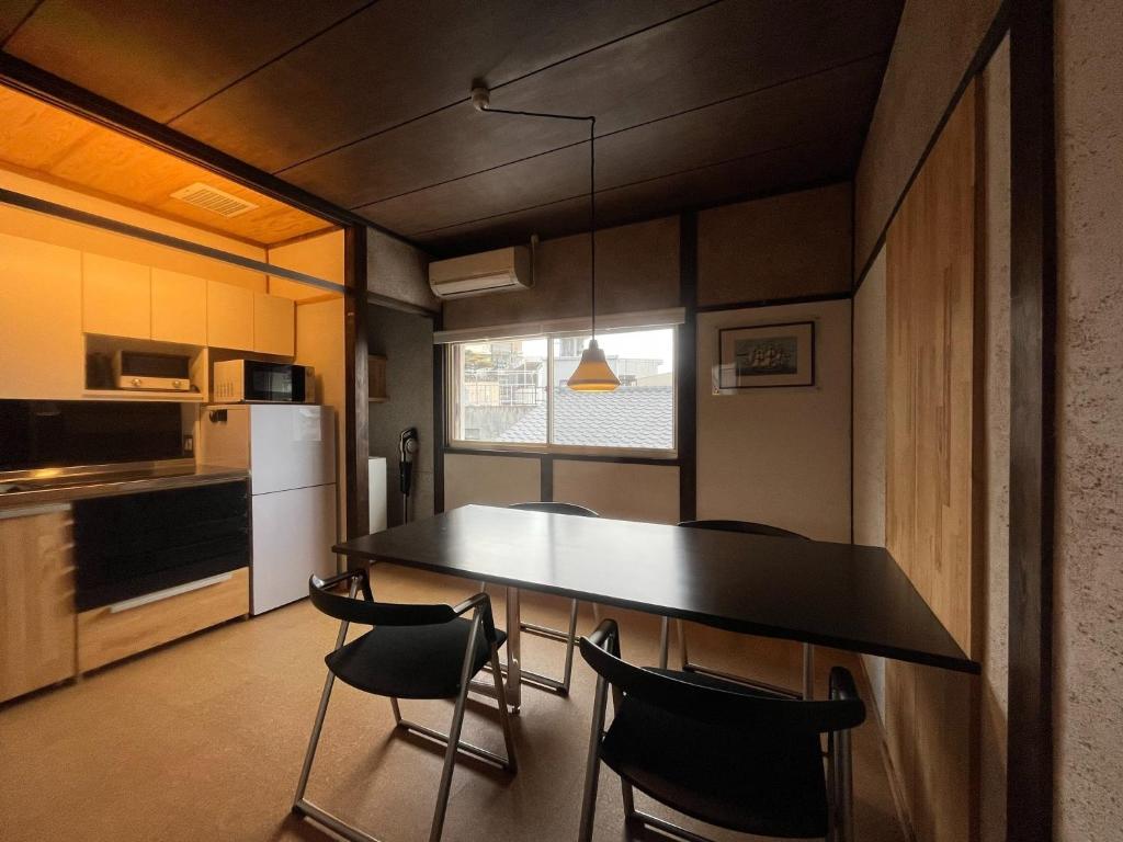 a kitchen with a table and chairs in a room at AKUNOURA HUIS - Vacation STAY 10922 in Nagasaki