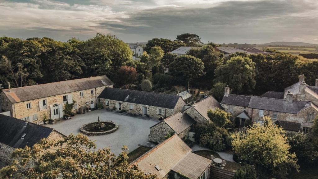 an aerial view of a large house with a fountain at Lambriggan Court in Perranzabuloe