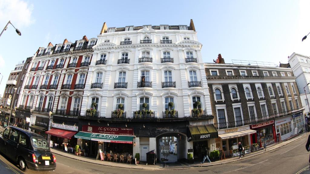 um grande edifício branco na esquina de uma rua em Ascot Hyde Park Hotel em Londres