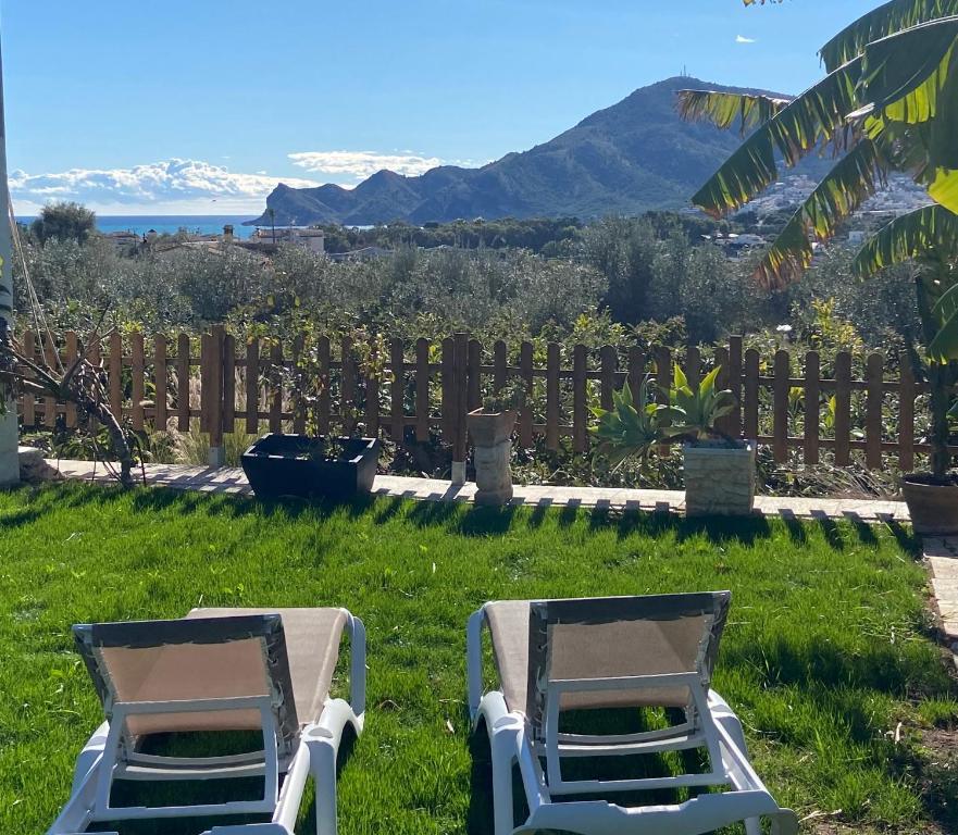 two lawn chairs sitting in the grass in a yard at Hotel Altea Paradise 1917 - Adults Only in Altea