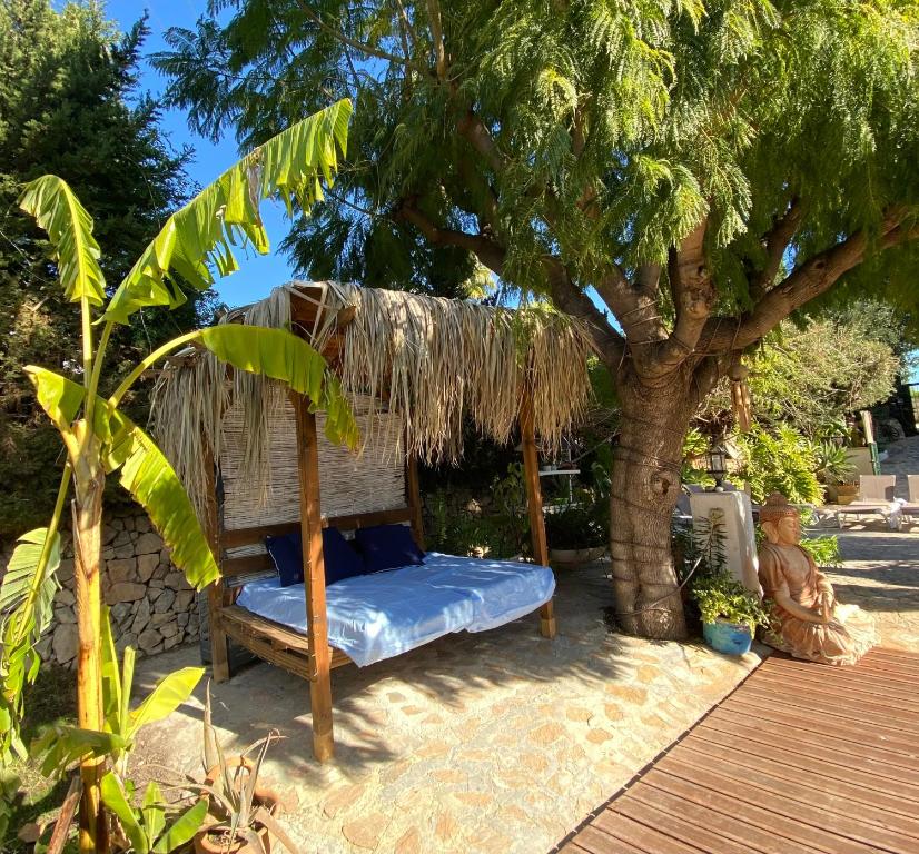 a bed under a tree with a thatch roof at Hotel Altea Paradise 1917 - Adults Only in Altea