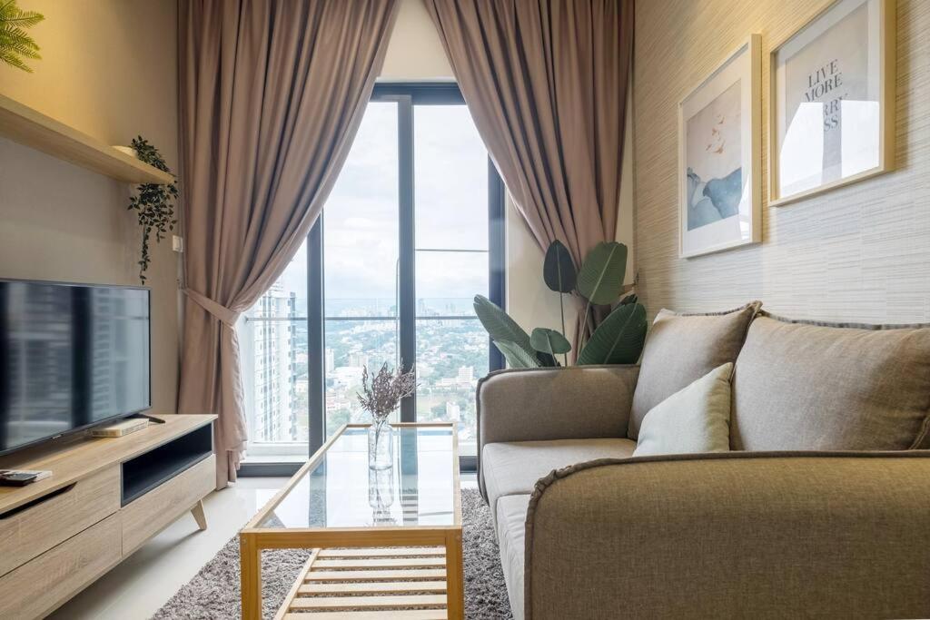 a living room with a couch and a large window at Muji Home 2BR 4Pax Southlink Nexus Bangsar South in Kuala Lumpur