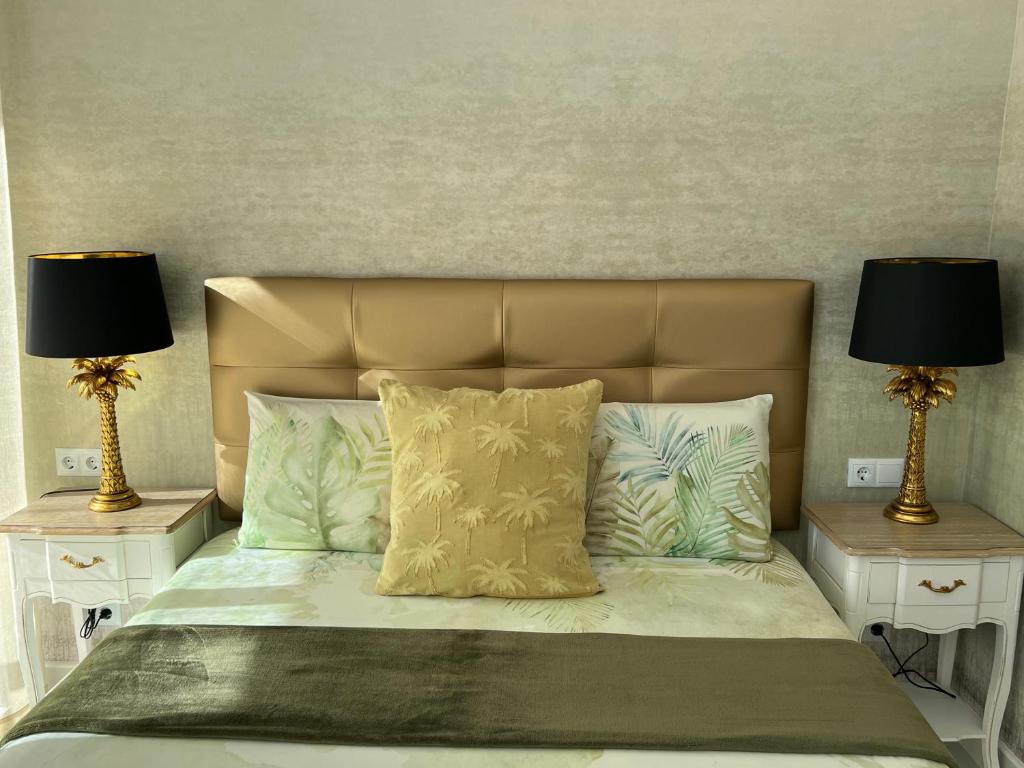 a bedroom with a bed with two lamps on both sides at Las Palmas in Marbella