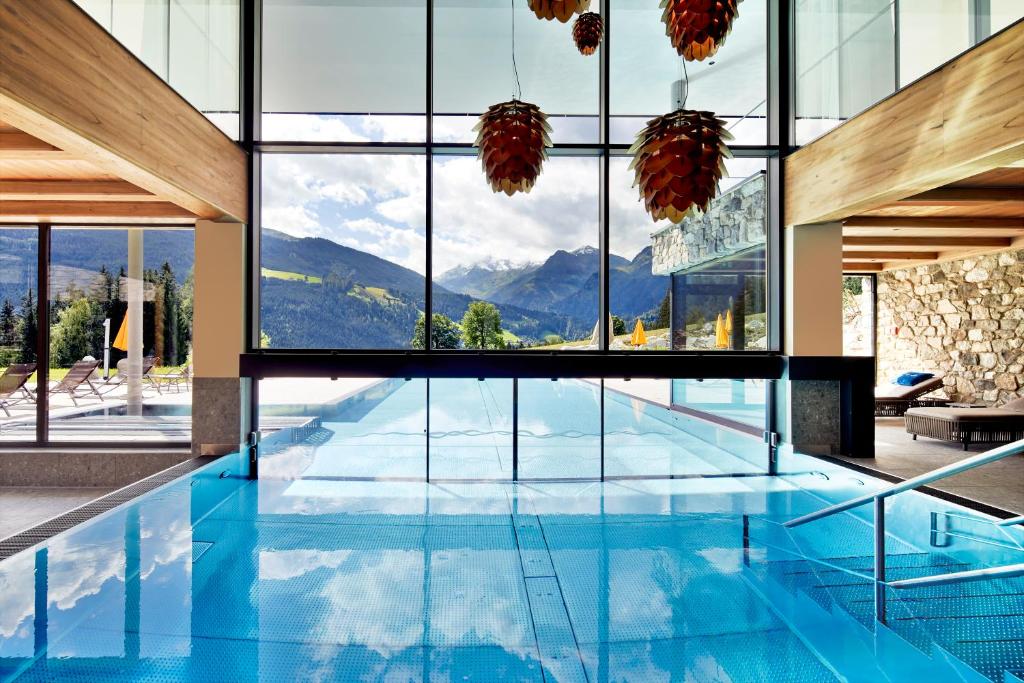 a pool with a view of the mountains from a house at Gut Sonnberghof in Mittersill