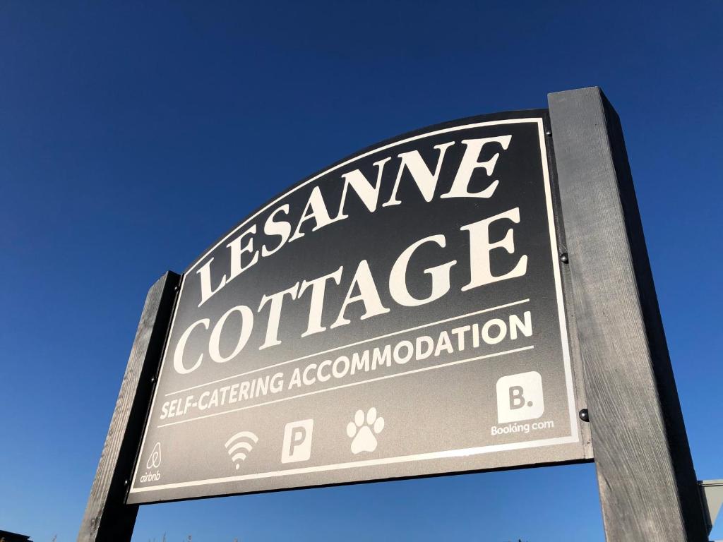 a sign for a insurance exchange on a street at Lesanne Cottage in Inverness