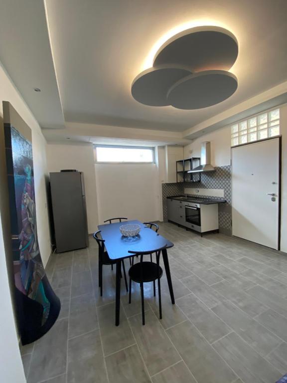 a living room with a table and a kitchen at Dbe apartment LA SIRENA in Francavilla al Mare