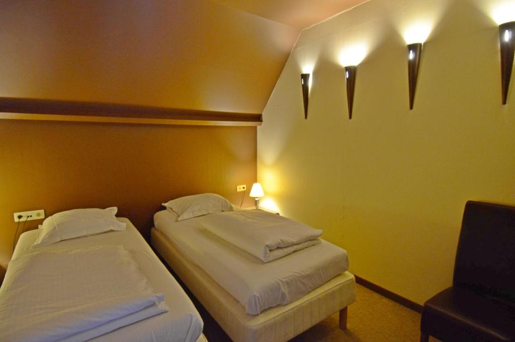 Postel nebo postele na pokoji v ubytování Hotel Malcot