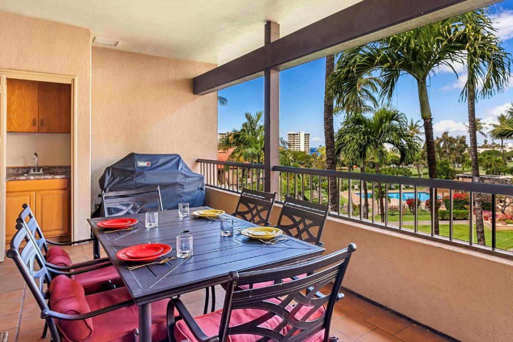 a table and chairs on a balcony with a view at Kaanapali Royal G303 condo in Lahaina