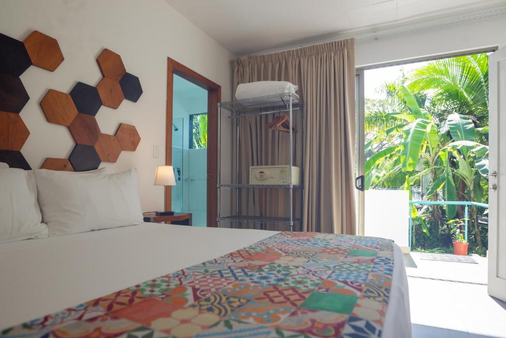 Postel nebo postele na pokoji v ubytování La Vela Boutique Hotel