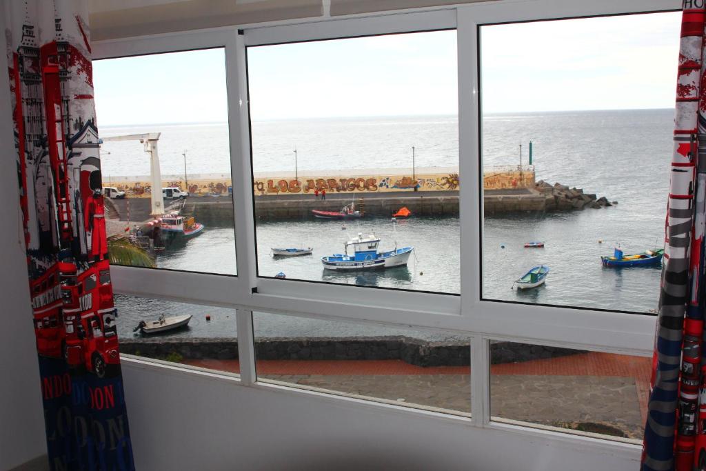 a view from a window of boats in the water at Los Abrigos Sea-Port View in Los Abrigos