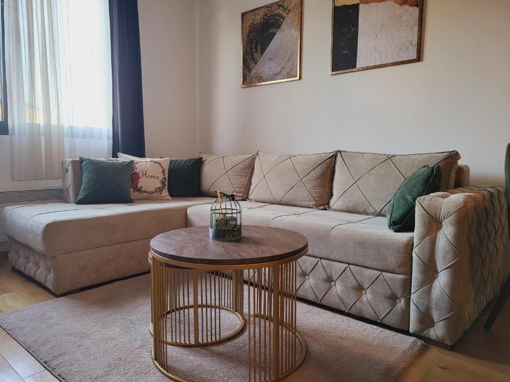 a living room with a couch and a table at Apartman Restart Zlatibor in Zlatibor