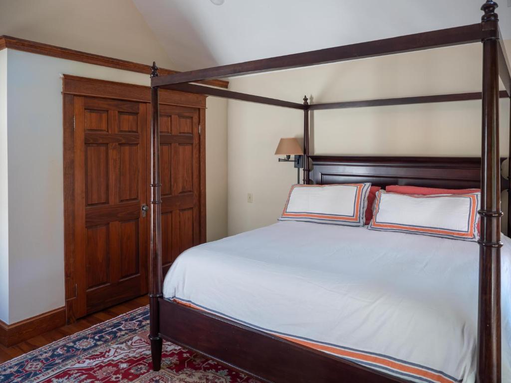 a bedroom with a bed with a wooden bed frame at Wren Retweet in Chestertown