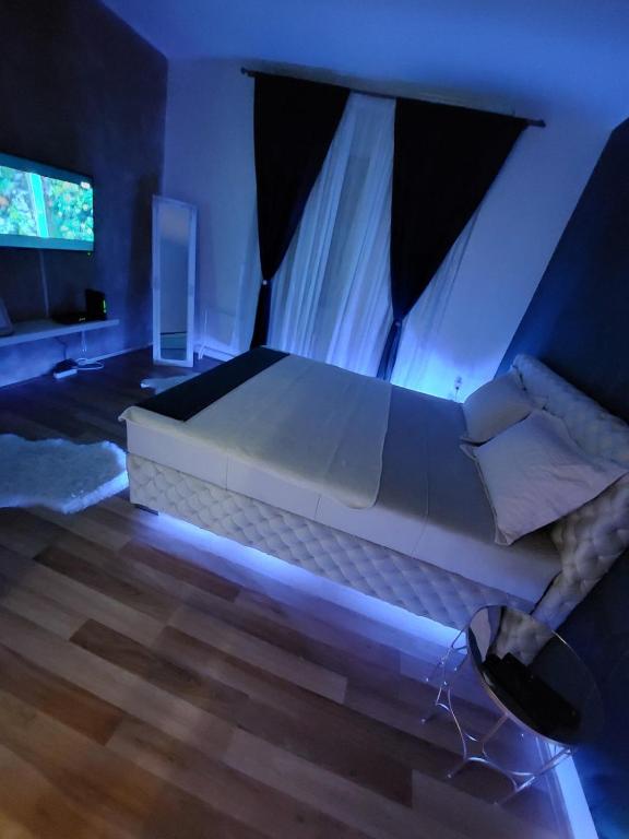 a bedroom with a large bed with a blue light at Creative studio 4 in Novi Sad