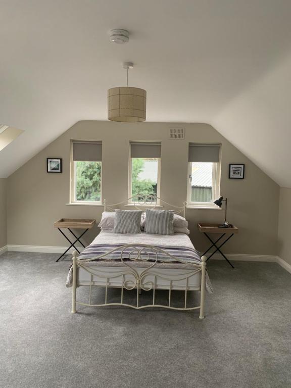 a bedroom with a large bed in a attic at The Mews in Newbridge