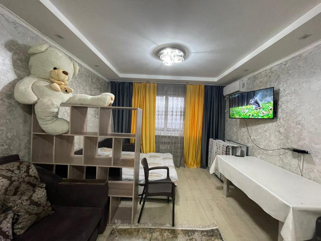 a bedroom with a bunk bed with a teddy bear at Студия в ЖК Ушсункар in Almaty