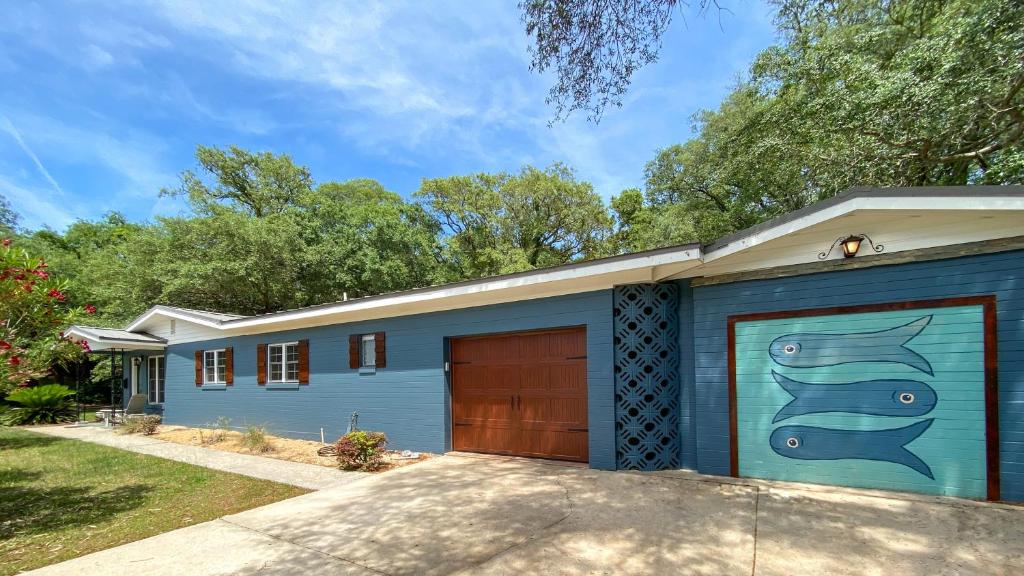 a blue garage with a painting of a fish on it at KISSES COTTAGE home in Jekyll Island