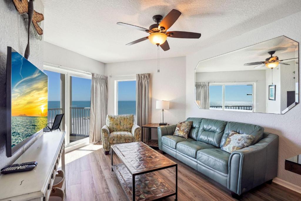 a living room with a couch and a flat screen tv at Sunset Vistas 603W in St Pete Beach