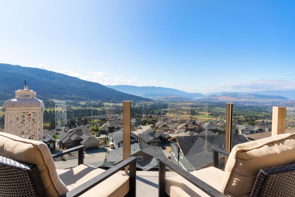 a balcony with chairs and a view of a city at 3 bed, 2 bath upper suite overlooking the city in Vernon