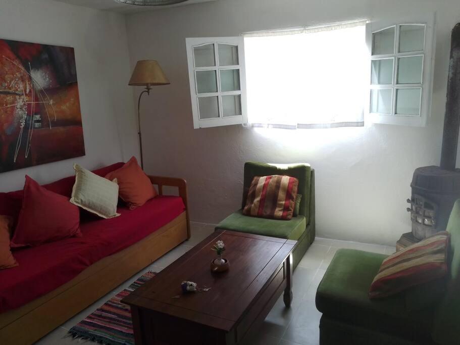 a living room with a couch and a coffee table at Casa Lola in Barra de Valizas