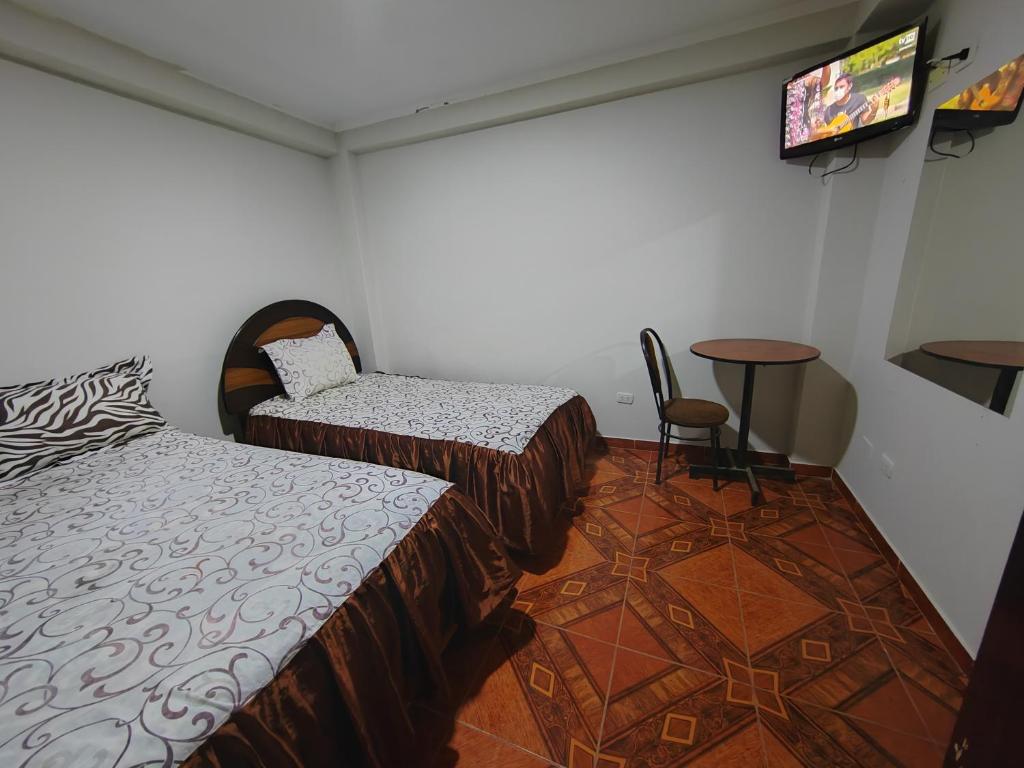Postel nebo postele na pokoji v ubytování Hostal Bryan