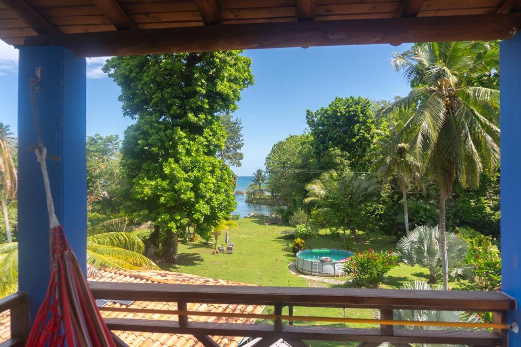 a view from the porch of a resort with a view of the water at Los Robles Capurgana in Capurganá
