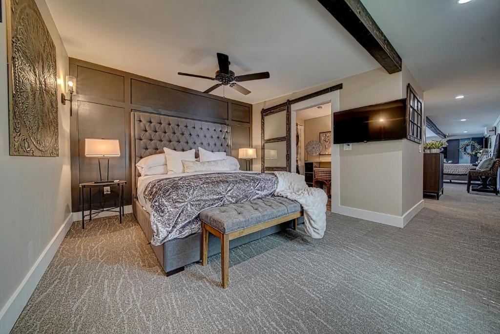 a bedroom with a large bed and a ceiling fan at Town Square Retreat in Blairsville