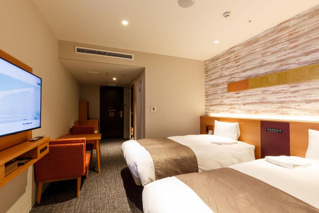 Postel nebo postele na pokoji v ubytování Keisei Hotel Miramare