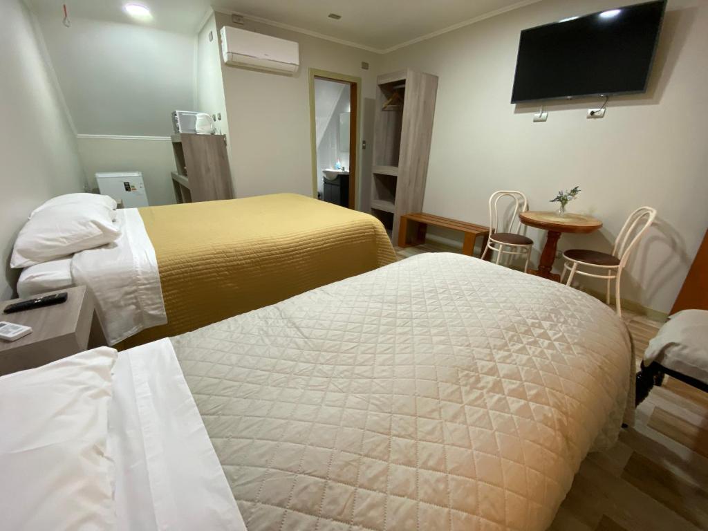 Postel nebo postele na pokoji v ubytování Hotel Casona Los Colonos