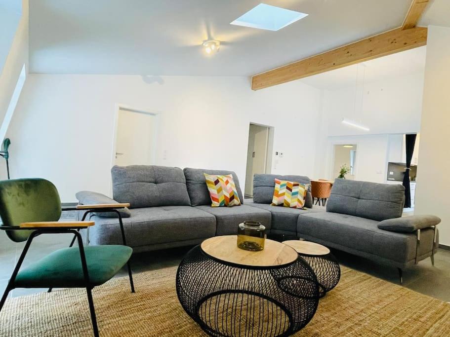 a living room with a couch and a table and chairs at Penthouse with Garden and Parking in Center- KPG in Luxembourg