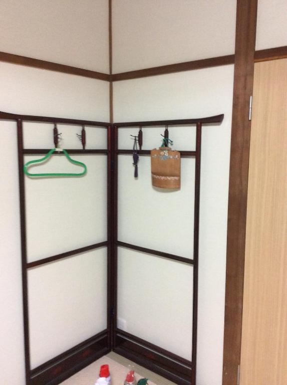 a room with three sliding glass doors with a purse at ハーモニーイン in Osaka